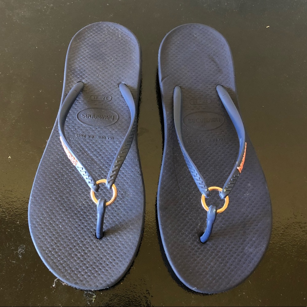 Ha is a navy and gold ring flip flop